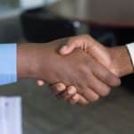 A person shaking hands with a financial adviser.