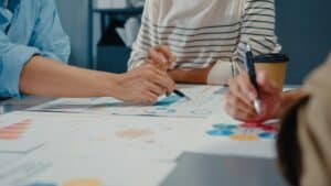 Financial advisers creating a financial plan around a table.