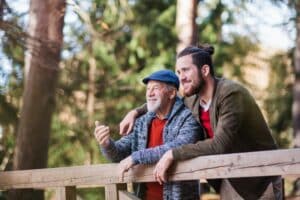 A retired man next to his son who is planning for retirement.