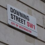 The Downing Street road sign that displays "DOWNING STREET SW1 - CITY OF WESTMINSTER"