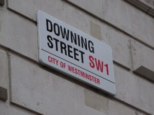 The Downing Street road sign that displays "DOWNING STREET SW1 - CITY OF WESTMINSTER"